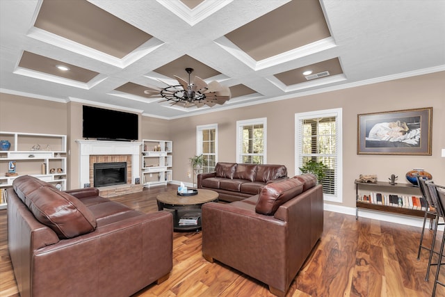 living room with ornamental molding, a brick fireplace, coffered ceiling, and hardwood / wood-style floors