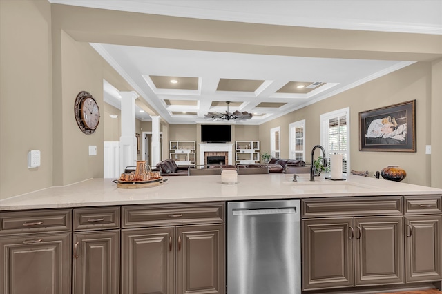 kitchen featuring sink, ornamental molding, coffered ceiling, stainless steel dishwasher, and light stone counters