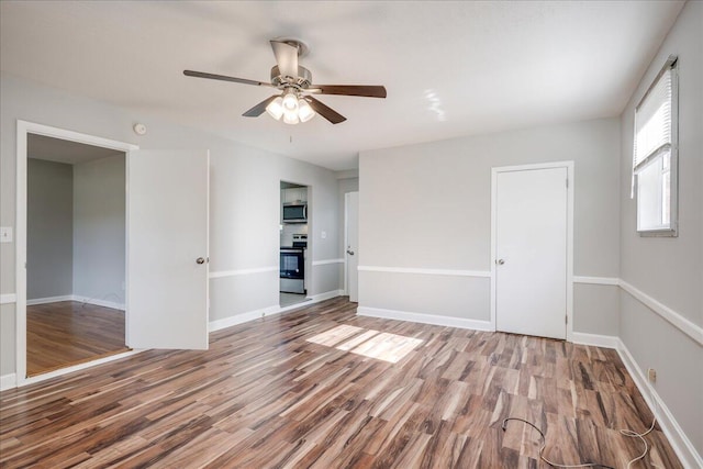 spare room with ceiling fan and hardwood / wood-style flooring