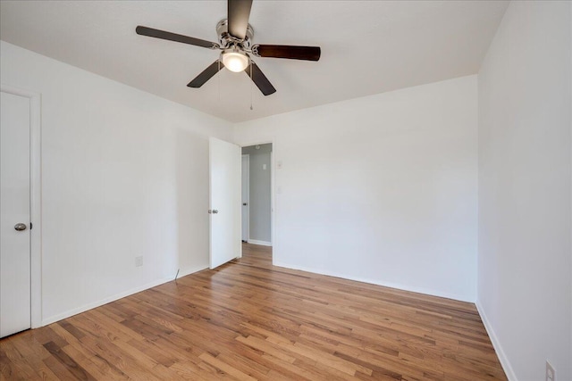 unfurnished room featuring ceiling fan and light wood-type flooring