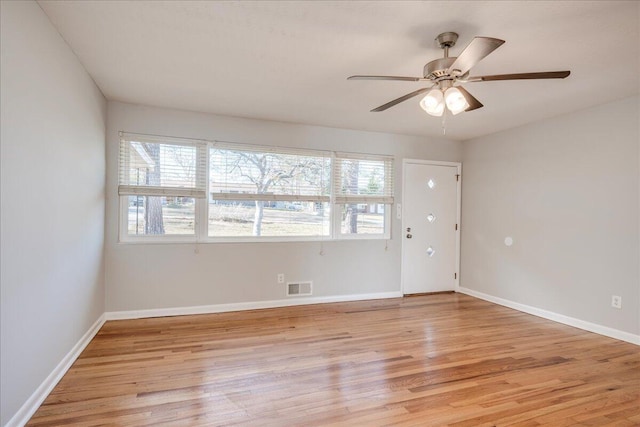 unfurnished room with ceiling fan and light hardwood / wood-style floors