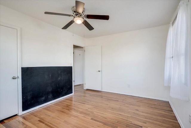 empty room featuring ceiling fan and light hardwood / wood-style floors