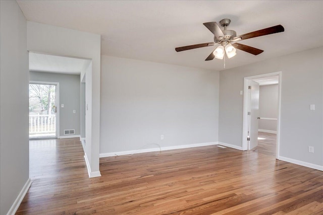 unfurnished room with ceiling fan and hardwood / wood-style flooring