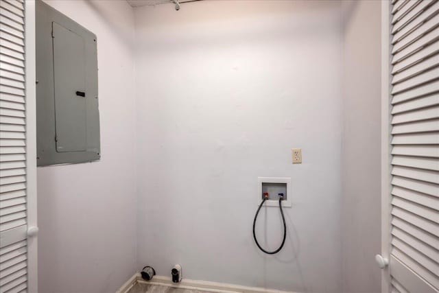 washroom featuring electric panel and hookup for a washing machine