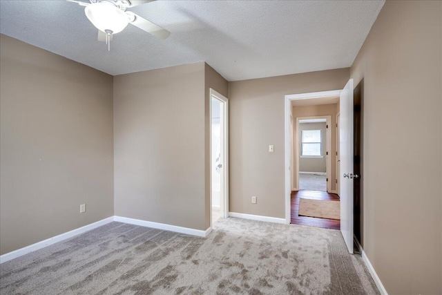 unfurnished bedroom featuring baseboards, carpet floors, and a textured ceiling