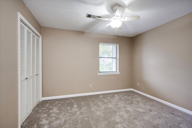 unfurnished bedroom featuring a closet, baseboards, visible vents, and carpet floors