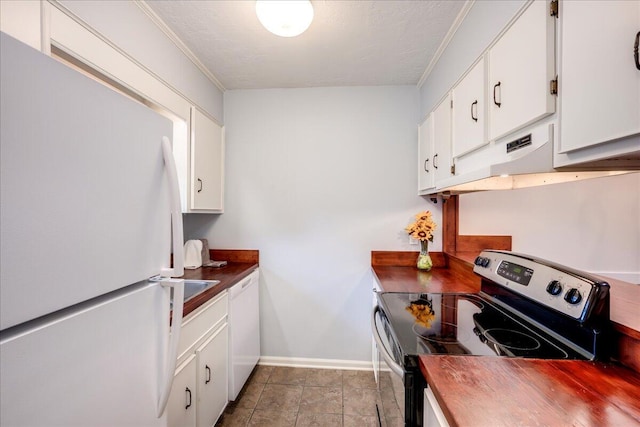 kitchen with under cabinet range hood, white cabinetry, white appliances, butcher block counters, and baseboards