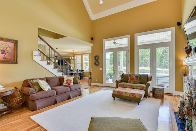 3005 Timber Woods Dr, Appling, GA 30802 - living room featuring crown molding, light wood-type flooring, stairway, french doors, and a fireplace