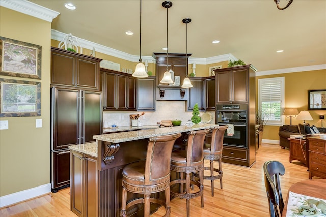 3005 Timber Woods Dr, Appling, GA 30802 - kitchen with paneled built in fridge, dark brown cabinets, light wood-style flooring, tasteful backsplash, and crown molding