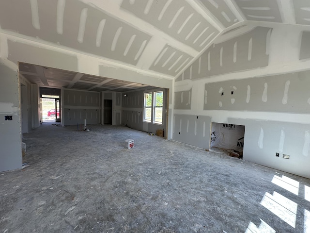unfurnished living room with vaulted ceiling