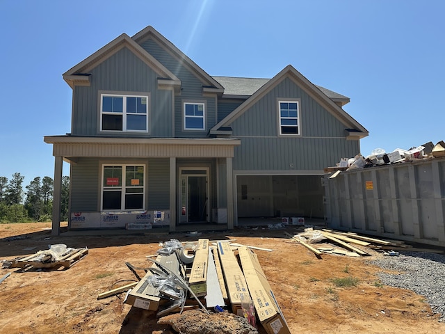 property under construction with a garage, board and batten siding, and covered porch