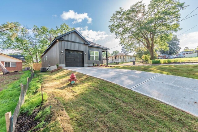 1717 Plank Rd, North Augusta, SC 29841 - view of front facade with central AC, an attached garage, fence, a front lawn, and driveway