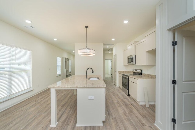 1717 Plank Rd, North Augusta, SC 29841 - kitchen with a sink, white cabinets, light wood finished floors, and stainless steel appliances