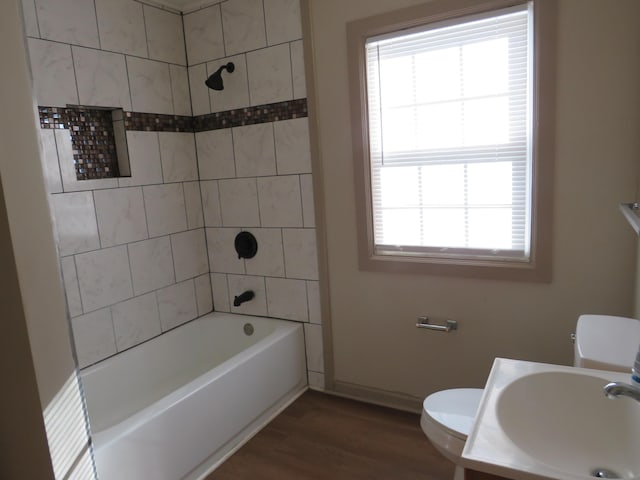 2810 Jordan St, Augusta, GA 30906 - full bathroom with baseboards, a sink, toilet, wood finished floors, and bathing tub / shower combination