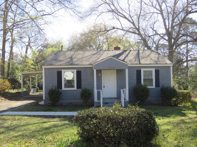 2810 Jordan St, Augusta, GA 30906 - view of front facade featuring roof with shingles, a chimney, and a front lawn