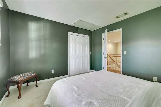 bedroom with a closet and light colored carpet