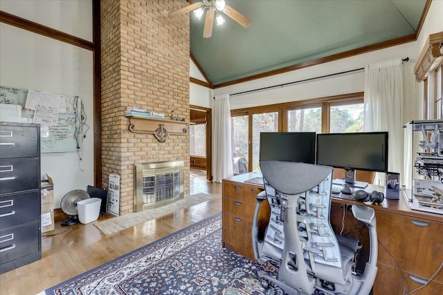 office area featuring a brick fireplace, ceiling fan, high vaulted ceiling, hardwood / wood-style floors, and crown molding