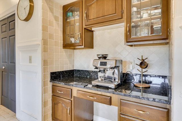 kitchen with tile walls, dark stone countertops, and decorative backsplash