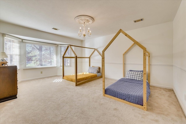 carpeted bedroom featuring a notable chandelier