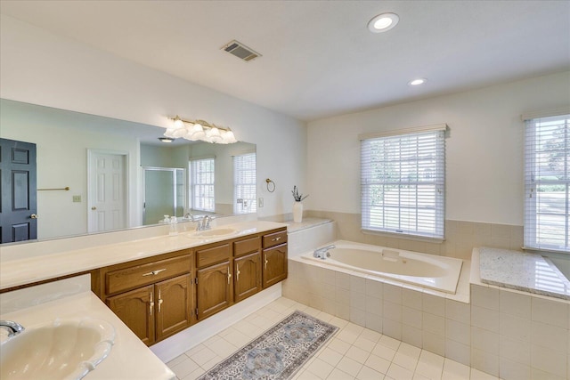 bathroom featuring shower with separate bathtub, tile patterned floors, a healthy amount of sunlight, and vanity