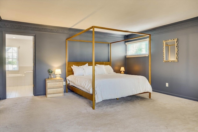 carpeted bedroom with multiple windows, ensuite bathroom, and crown molding