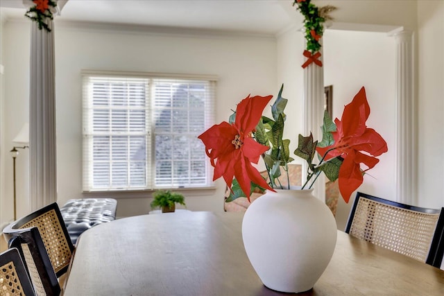 dining room featuring ornamental molding, ornate columns, and a wealth of natural light