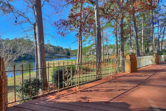 wooden terrace featuring a water view