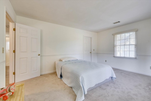 bedroom with light colored carpet