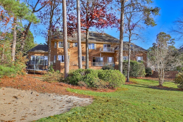 view of front of home featuring a trampoline and a front lawn