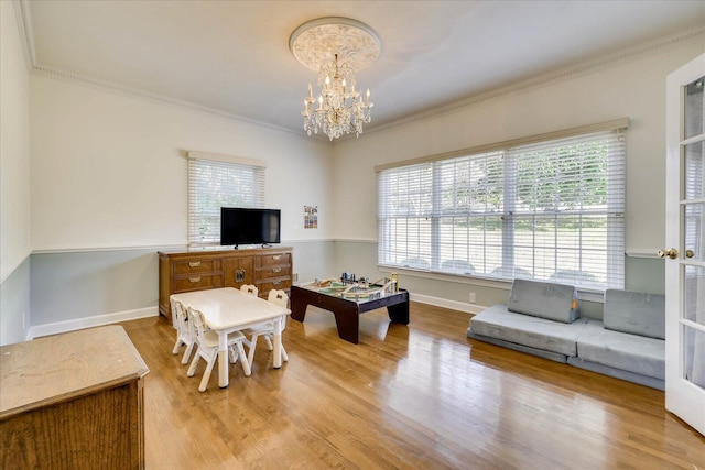 living room featuring hardwood / wood-style floors, a healthy amount of sunlight, and ornamental molding