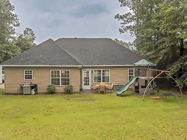 165 Sudlow Lake Rd, Graniteville, SC 29829 - rear view of property featuring a playground, a lawn, roof with shingles, a trampoline, and a patio area