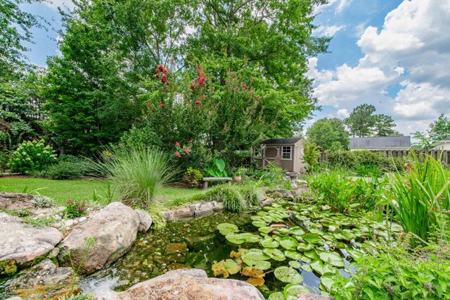 3039 Tarleton Ct, Beech Island, SC 29842 - view of yard featuring a storage unit and a garden pond