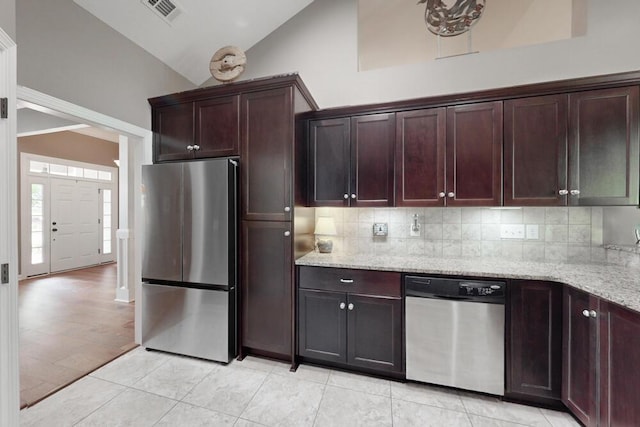 3039 Tarleton Ct, Beech Island, SC 29842 - kitchen featuring appliances with stainless steel finishes, vaulted ceiling, backsplash, light stone counters, and light tile patterned flooring
