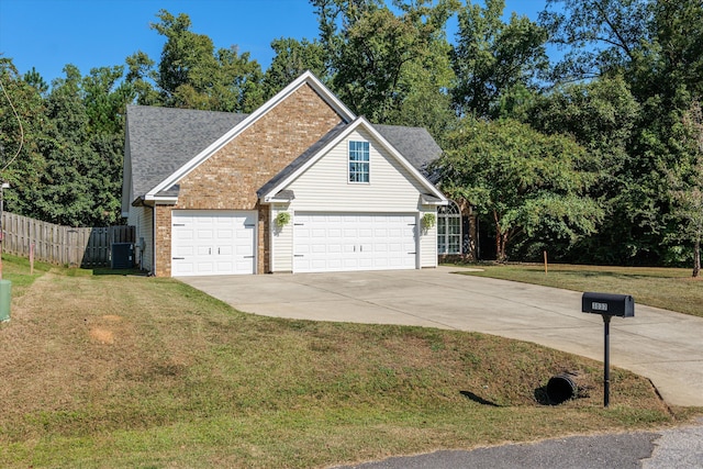 view of front facade featuring a garage, central AC unit, and a front yard