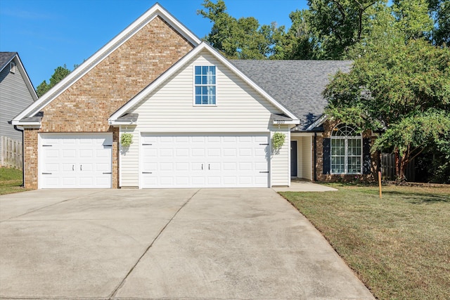 view of front of home with a garage and a front yard