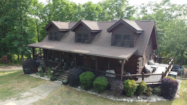 545 Beech Island Ave, Beech Island, SC 29842 - log-style house with a front yard, log siding, a shingled roof, a porch, and view of scattered trees