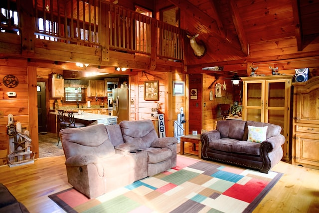 545 Beech Island Ave, Beech Island, SC 29842 - living room with wood walls, light wood-style floors, high vaulted ceiling, a ceiling fan, and a wood ceiling with exposed beams
