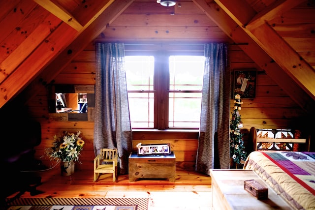 545 Beech Island Ave, Beech Island, SC 29842 - bedroom with vaulted ceiling, wood walls, multiple windows, and wood-type flooring