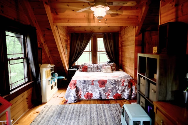 545 Beech Island Ave, Beech Island, SC 29842 - bedroom with wooden walls, multiple windows, light wood-style flooring, and beam ceiling