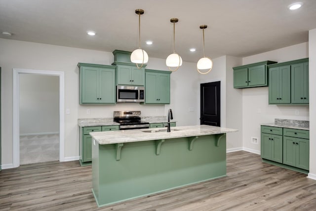 1962 Bunting Dr, North Augusta, SC 29841 - kitchen featuring appliances with stainless steel finishes, green cabinetry, light wood-style floors, and recessed lighting