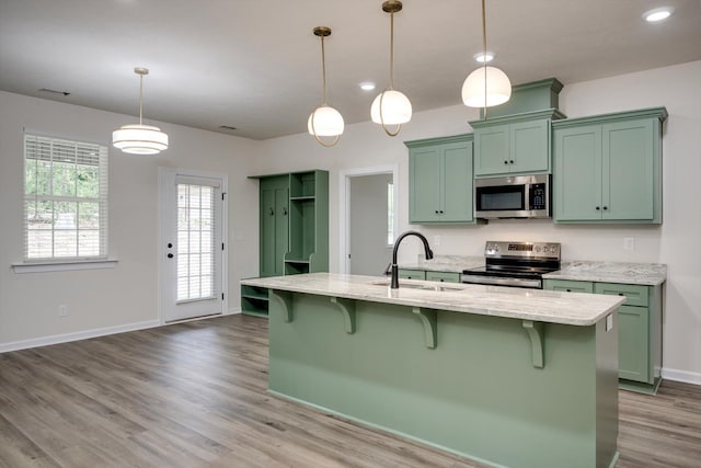 1962 Bunting Dr, North Augusta, SC 29841 - kitchen featuring appliances with stainless steel finishes, green cabinetry, wood finished floors, and light stone counters