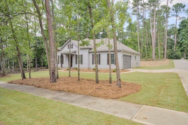 1962 Bunting Dr, North Augusta, SC 29841 - view of front facade featuring a front lawn, roof with shingles, driveway, and view of scattered trees