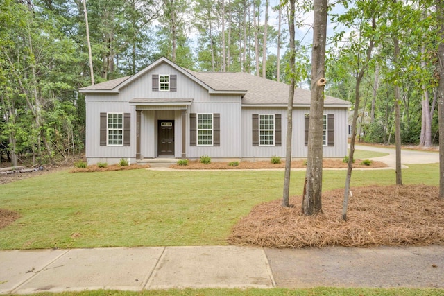 1962 Bunting Dr, North Augusta, SC 29841 - modern farmhouse style home with a shingled roof, a front lawn, and view of wooded area