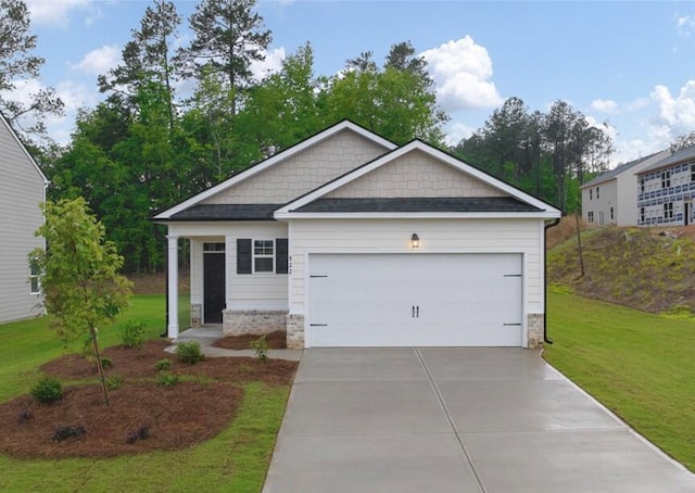 craftsman inspired home with a garage and a front yard