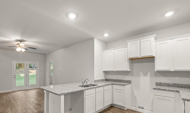 2912 Saltwater Bnd, Beech Island, SC 29842 - kitchen featuring white cabinetry, sink, dark wood-type flooring, and light stone counters