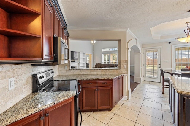 kitchen with light stone countertops, ornamental molding, light tile patterned floors, a textured ceiling, and appliances with stainless steel finishes