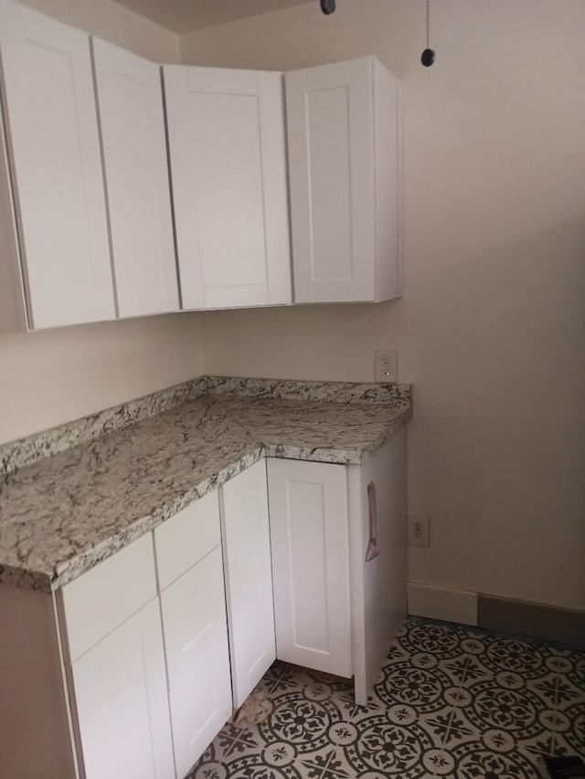 1310 Baker Ave, Augusta, GA 30904 - kitchen featuring light countertops, white cabinets, and baseboards