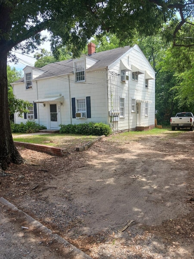 1310 Baker Ave, Augusta, GA 30904 - view of front of home with a chimney, cooling unit, driveway, and roof with shingles