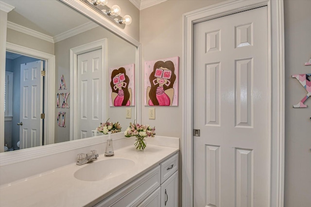 bathroom featuring ornamental molding, vanity, and toilet