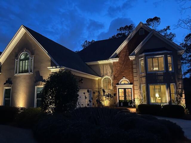 traditional-style home with an attached garage and stucco siding